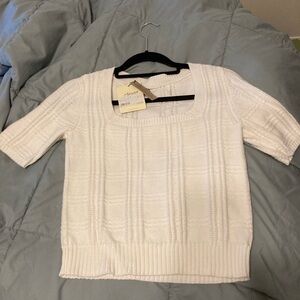 Cream/white square neck sweater with short sleeves.